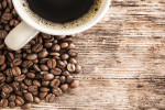 Coffee cup and beans on a wooden table